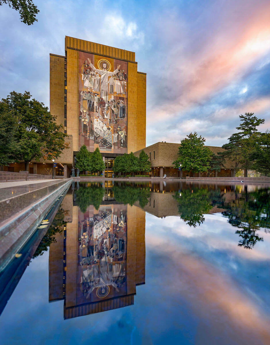 Hesburgh Library and reflecting pool at sunrise