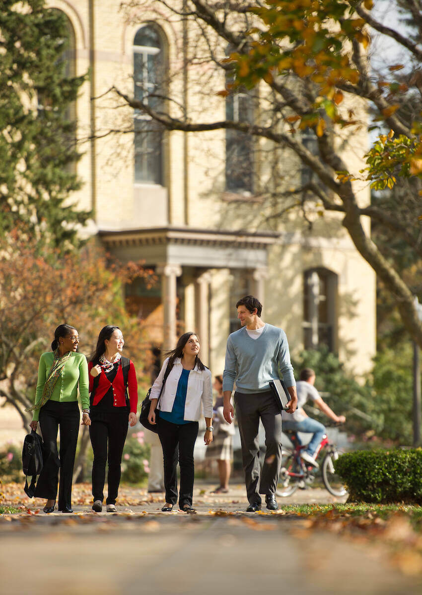 Students walking across campus in the fall